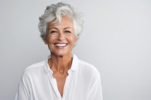 an image of a woman smiling with implant supported dentures.